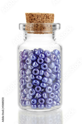 Photo: Little bottle full with colorful beads isolated on white Little bottle full with colorful beads isolated on white