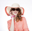 Beautiful red-haired girl in hat at white background