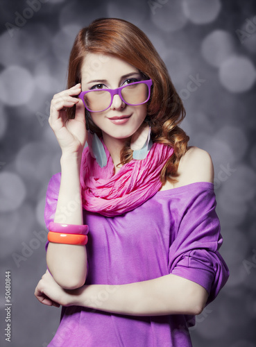 Photo: Beautiful red-haired girl at bokeh background Beautiful red-haired girl at bokeh background