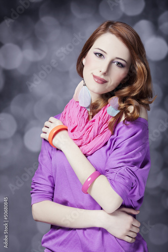 Photo: Beautiful red-haired girl at bokeh background Beautiful red-haired girl at bokeh background