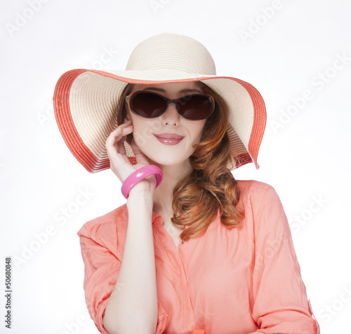 Photo: Beautiful red-haired girl in hat at white background Beautiful red-haired girl in hat at white background