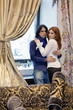 Portrait of young couple beside window