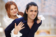 Smiling couple, she embrace him from behind