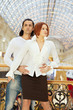 Dark-haired man embrace red-haired woman from behind