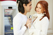 Dark-haired man with credit card in hand and red-haired woman