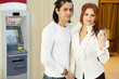 Dark-haired man and red-haired woman stand