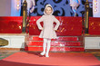 Girl walks runway during kids fashion show