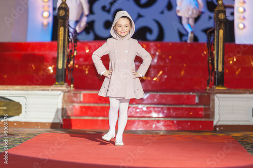 Photo: Girl walks runway during kids fashion show Girl walks runway during kids fashion show