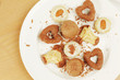 Photo: Several kinds of cookies and cakes on plate with crumbs Several kinds of cookies and cakes on plate with crumbs