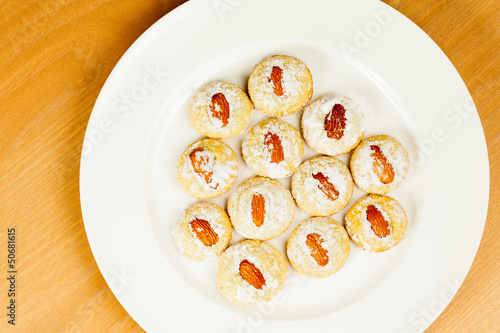 Photo: Coocies with almond nuts and sugar powder on plate Coocies with almond nuts and sugar powder on plate