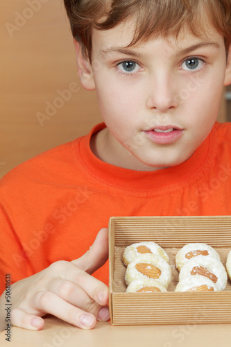 Photo: Boy in orange t-shirt holds open box of corrugated cardboard Boy in orange t-shirt holds open box of corrugated cardboard