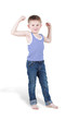 Smiling boy strains biceps and shows how strong he is