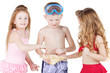 Boy and two girls in beach suits, boy holds big seashell