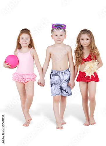 Photo: Three children in beach suits go holding hands Three children in beach suits go holding hands