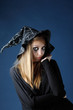 Pretty zombie girl with black tears and cut throat in black hat