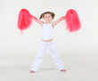 Little barefoot girl with funny hairdo holds pompon