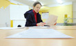 Woman reads documents in elections to State Duma