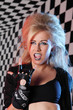 Photo: Young woman rocker in biker gloves screams in studio Young woman rocker in biker gloves screams in studio