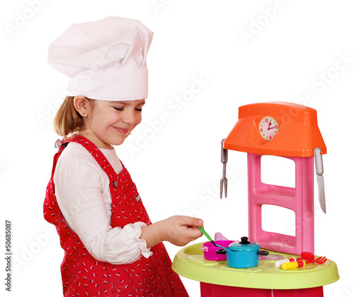 Photo: happy little girl play cooking happy little girl play cooking