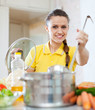 woman cooking  in saucepan at home
