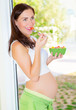 Pregnant girl eating salad