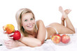 Photo: Cheerful girl in bed surrounded by apples. Cheerful girl in bed surrounded by apples.