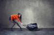 Beautiful woman carrying heavy bag  with some difficulty