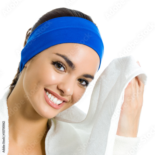 Photo: Cheerful woman in fitness wear with towel, over white Cheerful woman in fitness wear with towel, over white