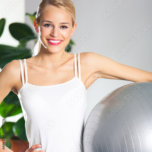 Photo: Woman with fitball at home Woman with fitball at home