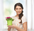 lovely housewife with flower in pot