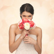 woman smelling bouquet of flowers