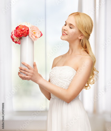 Photo: woman with vase of flowers woman with vase of flowers