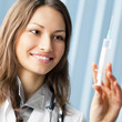 Happy doctor with syringe at office