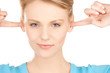 woman closing her ears with fingers