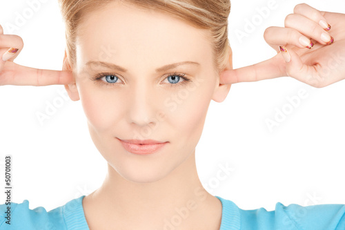 Photo: woman closing her ears with fingers woman closing her ears with fingers