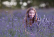 Young woman in the field of blossoming lavender