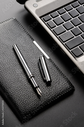 Photo: Laptop, card holder, fountain pen Laptop, card holder, fountain pen