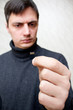 A man look at micro SD computer memory card