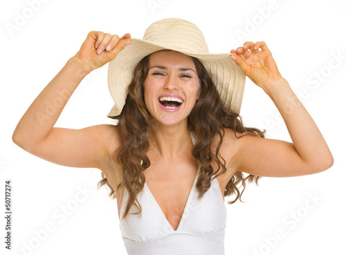 Photo: Portrait of smiling young woman in swimsuit and hat Portrait of smiling young woman in swimsuit and hat