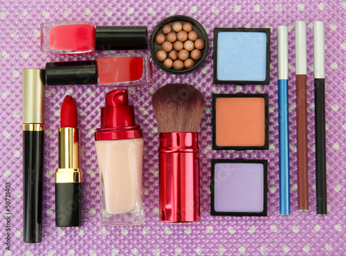 Photo: Decorative cosmetics on purple background Decorative cosmetics on purple background