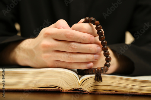 Photo: Priest reading from the holy bible, close up Priest reading from the holy bible, close up