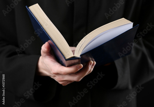 Photo: Priest reading from the holy bible, close up Priest reading from the holy bible, close up