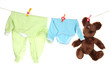 Baby clothes hanging on clothesline, isolated on white