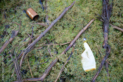 Photo: Weathered garbage embedded in ground Weathered garbage embedded in ground