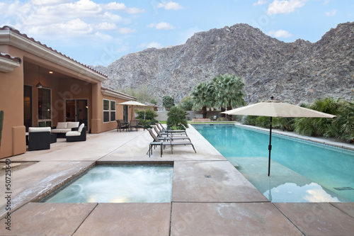 Photo: Rear view of luxury villa with swimming pool Rear view of luxury villa with swimming pool