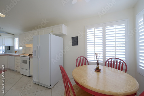 Photo: Classic kitchen with dining table with red chairs Classic kitchen with dining table with red chairs