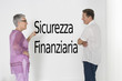 Photo: Couple discussing financial security against white wall with Italian text "Sicurezza Finanziaria" Couple discussing financial security against white wall with Italian text "Sicurezza Finanziaria"