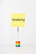 Photo: Sticky notepaper with Dutch text "Verzekering" (Insurance) clipped to a multicolored card holder Sticky notepaper with Dutch text "Verzekering" (Insurance) clipped to a multicolored card holder