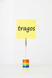 Photo: Sticky notepaper with Spanish text "Tragos" (Drinks) clipped to a multicolored card holder Sticky notepaper with Spanish text "Tragos" (Drinks) clipped to a multicolored card holder