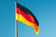 German flag against blue sky